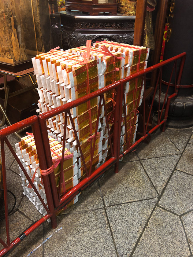 Bales of joss money for sale to worshippers.