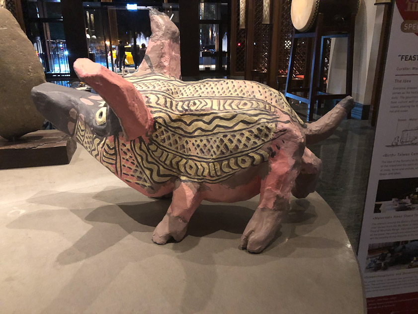 The lobby had a collecton of large pigs.