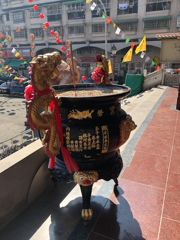 Temples also often have large pots with sand to hold burning sticks of incense.