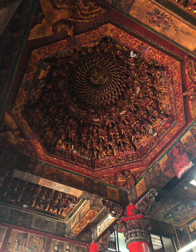 The ceiling is very intricate woodwork.