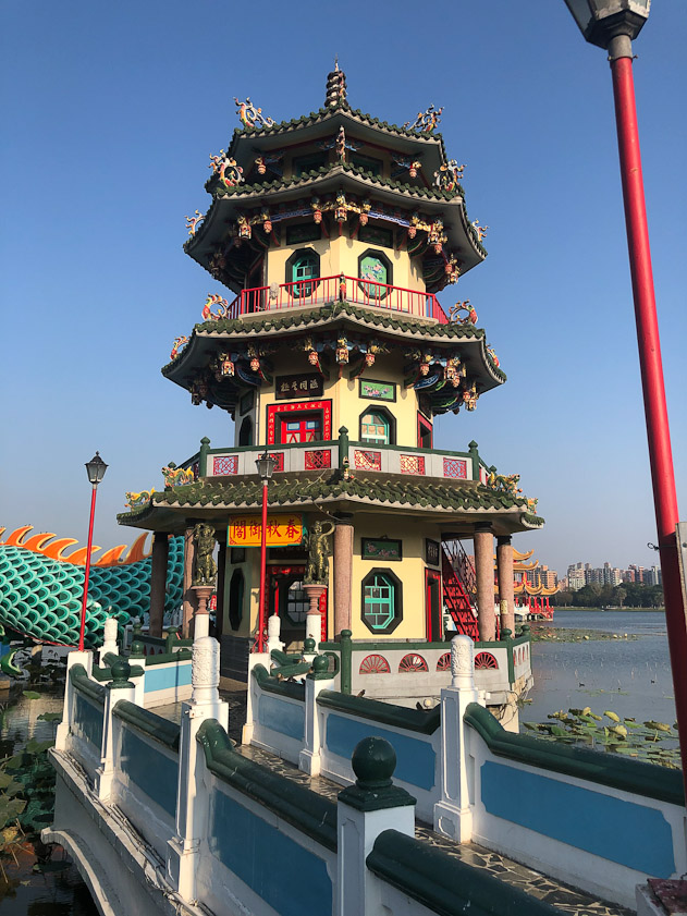 There are two towers near the shore, with a dragon between them.