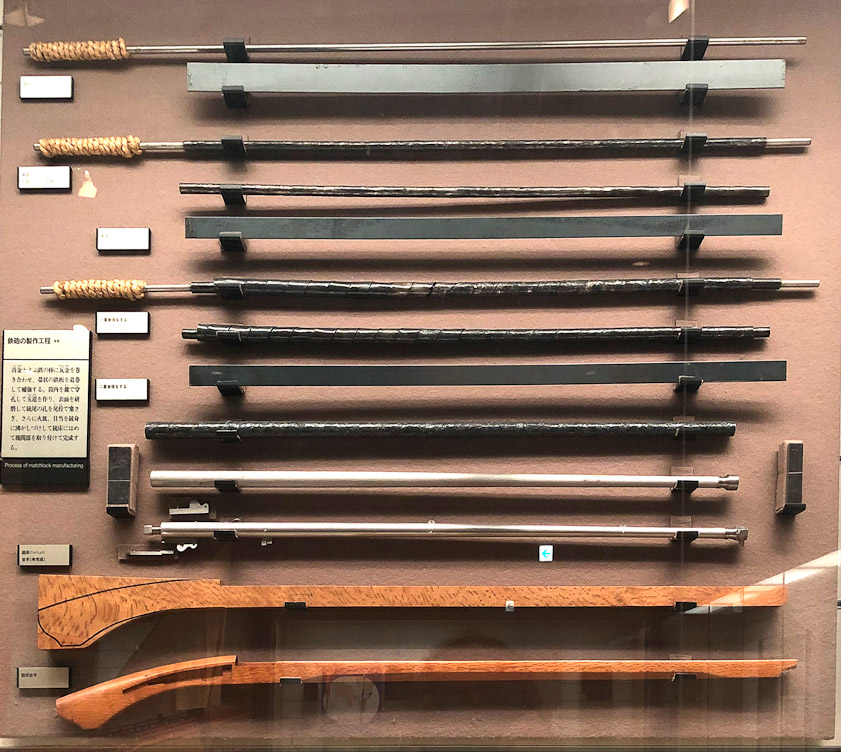 A display about the steps in making a gun. I gather that a barrel was formed by wrapping strips of steel around a mandrel in three layers. The welding process is not explained, nor any reaming or boring.