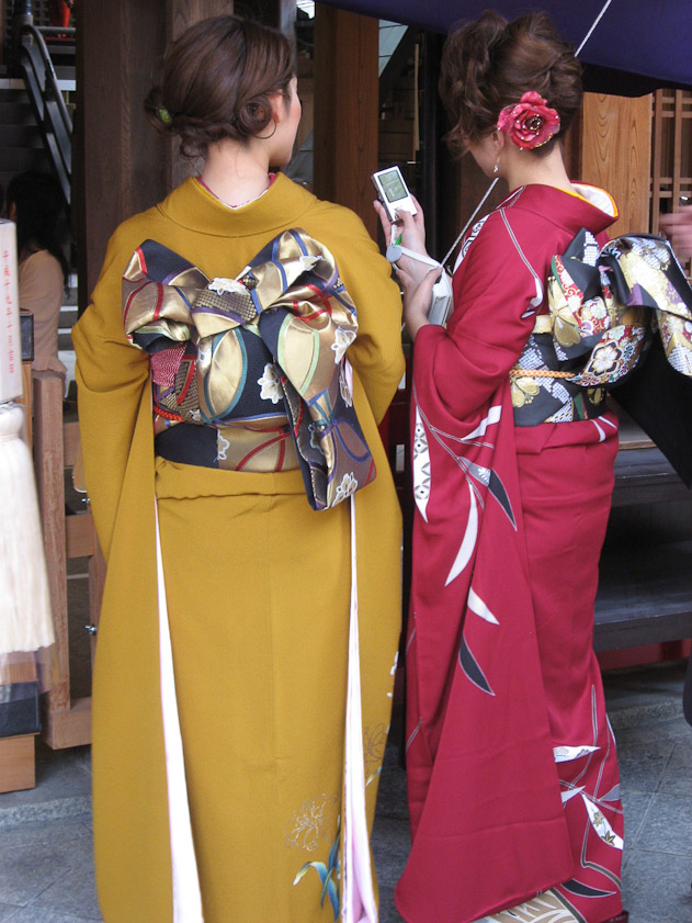 Wedding guests in kimonos with elaborate obis.