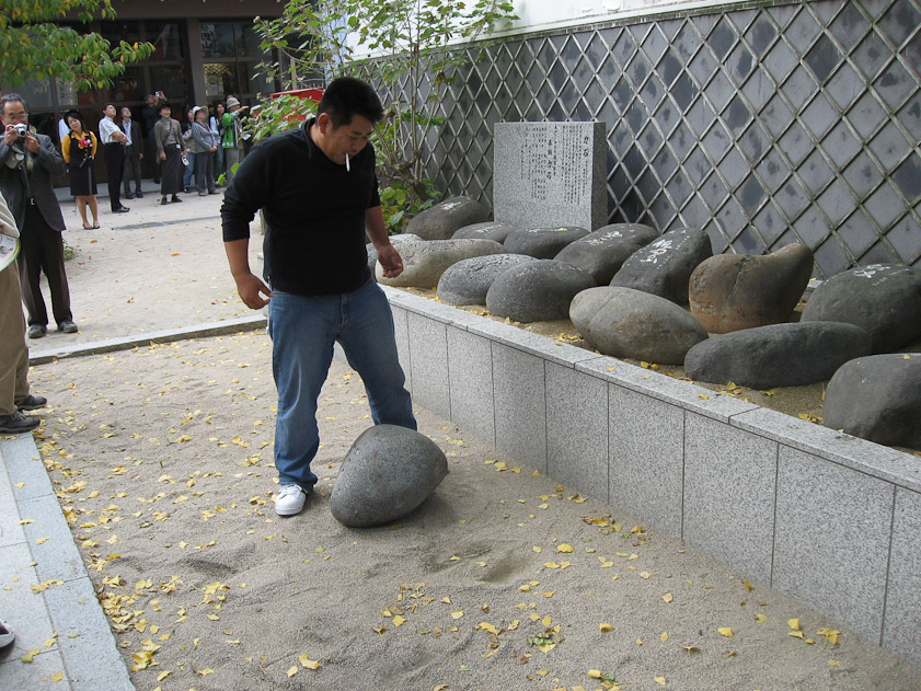 Something good is achieved when one of these rocks are heaved onto the ledge. This guy was trying to move a rock.