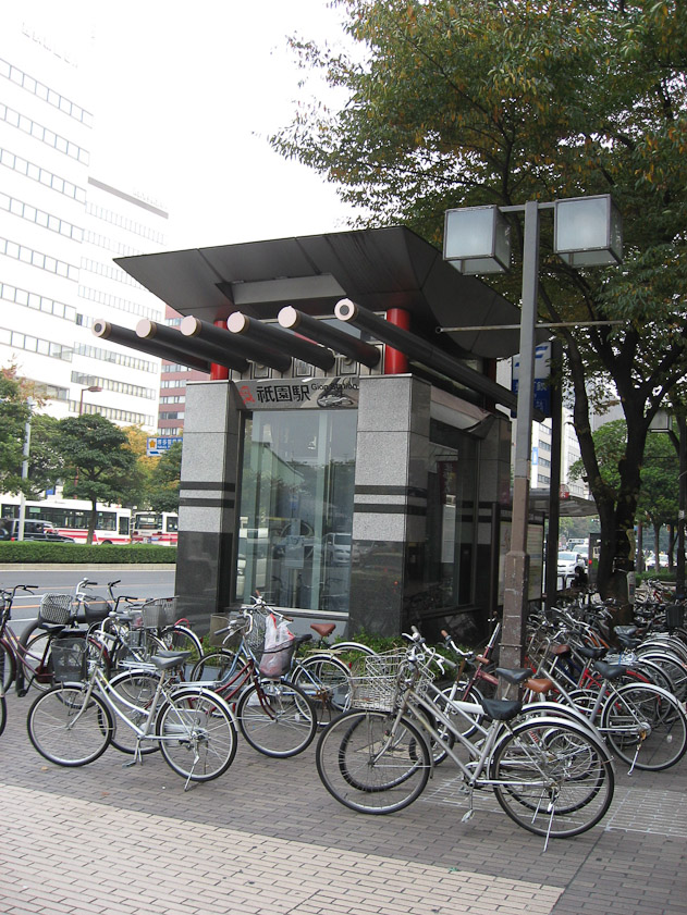 Subway entrance near the shrine. The horizontal poles on top refer to the billets across the roof of a shrine building.