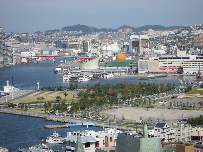 The view north, upriver from Glover Garden. The foreground park, the area with the green building with the orange ball (a shopping center), and the red bridge are new fill and new structures since WW II.