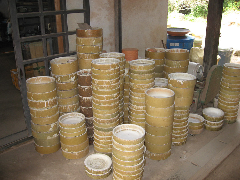 Work sealed inside these saggars is shielded from the ash of the fire in the kiln.
