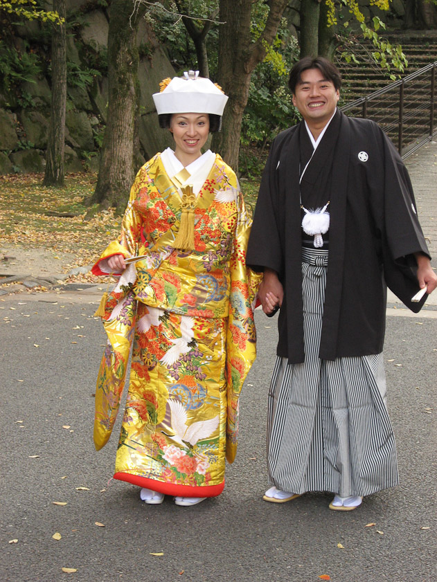 A couple having their photos taken in Osaka Castle grounds. This is probably after the wedding.