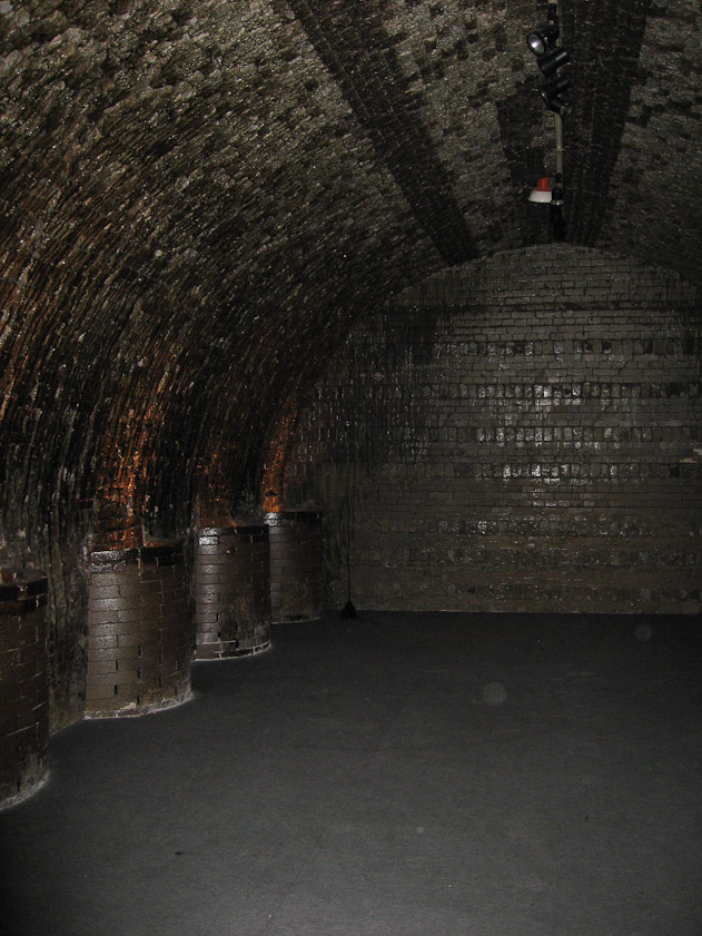 Fireboxes tended outside the kiln sent hot flue gasses into the kiln through the round vents on the left.