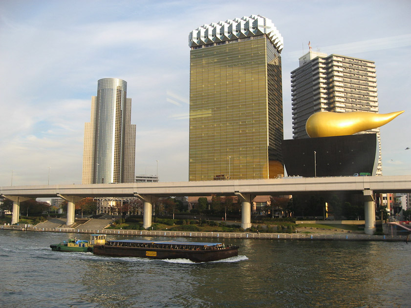 Wild buildings across the river from Asakusa in Tokyo. The golden sweet potato and the gold building next to it are headquarters of Asahi Beer, designed by Philippe Starck.