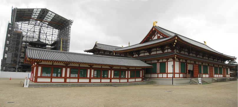 The lecture hall at Yakushiji on the right, the main building beyond it, and on the left the older of the two pagodas, from 698, being restored under cover.