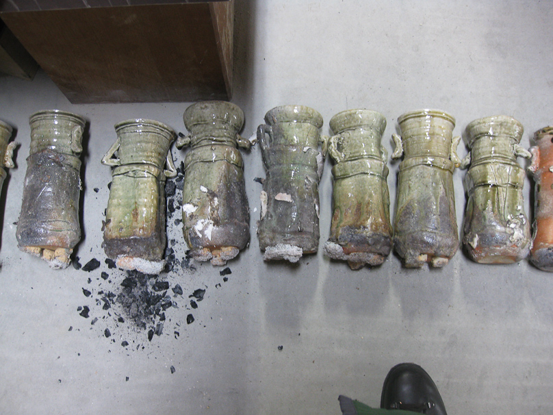 The bottoms of these two-handled vases were buried in ash by the end of the firing, and have to be cleaned up by grinding.