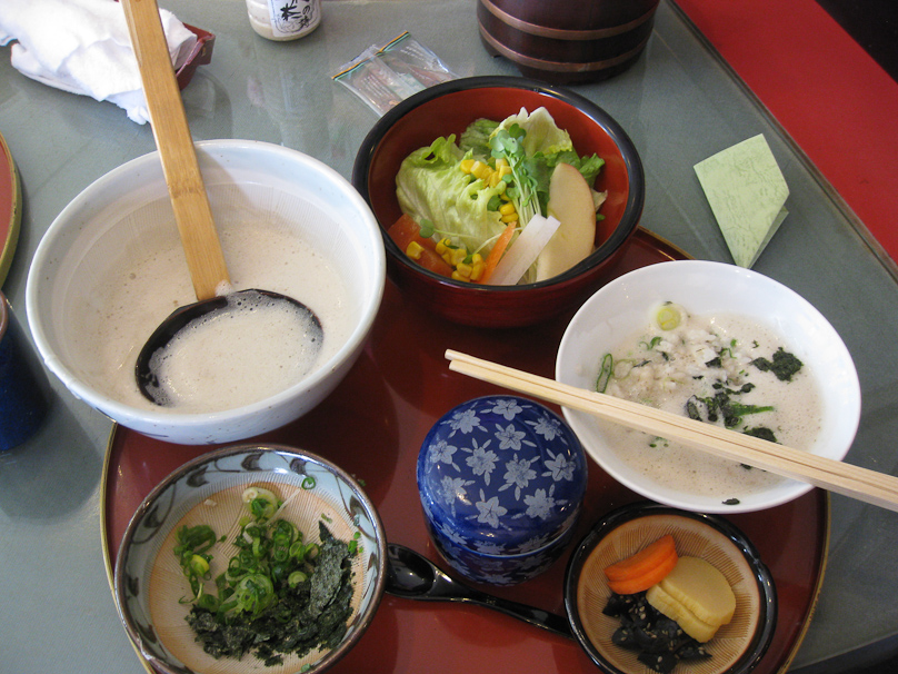 The wild  yam is in the thick, frothy sauce in the bowl with the ladle. It was poured over the rice in the bowl on the right and eaten.