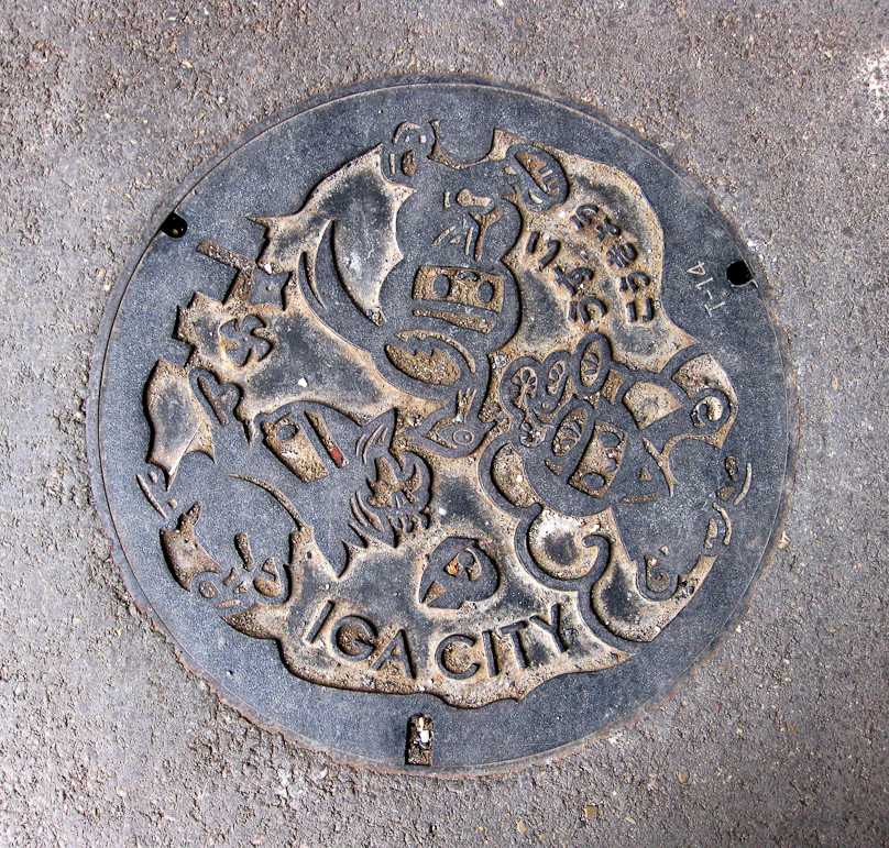Manhole cover found in Ueno, which is part of Iga City. Ueno is famous for being the home of ninja, and this shows three cartoon ninjas, their faces covered by masks revealing only their eyes.