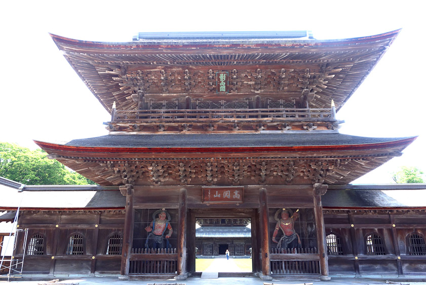 From closeup the intricacy of the carpentry supporting the roof of the gate can be seen.