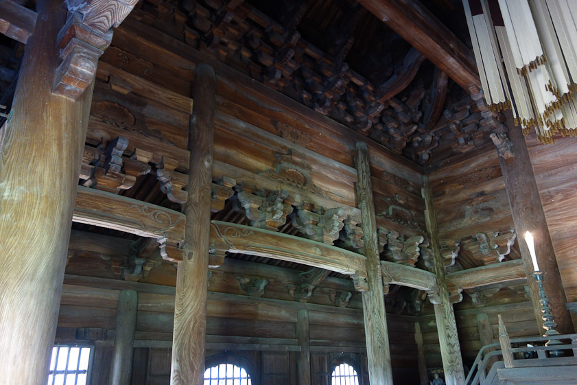 The wood fixtures attached to the columns that support horizontal beams are called brackets. The complicated piles on top of the horizontal beams holding up other beams are also called brackets. The profusion of brackets between the columns is one characteristic of the Zen style of Japanese temple architecture.