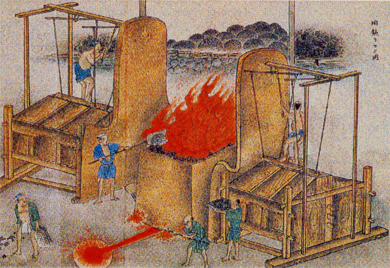 This old drawing shows the stoker at left feeding the tatara with shovels of iron sand and charcoal. Men at right and left are working bellows to supply air to the fire. Presumably slag is being drained off the bottom