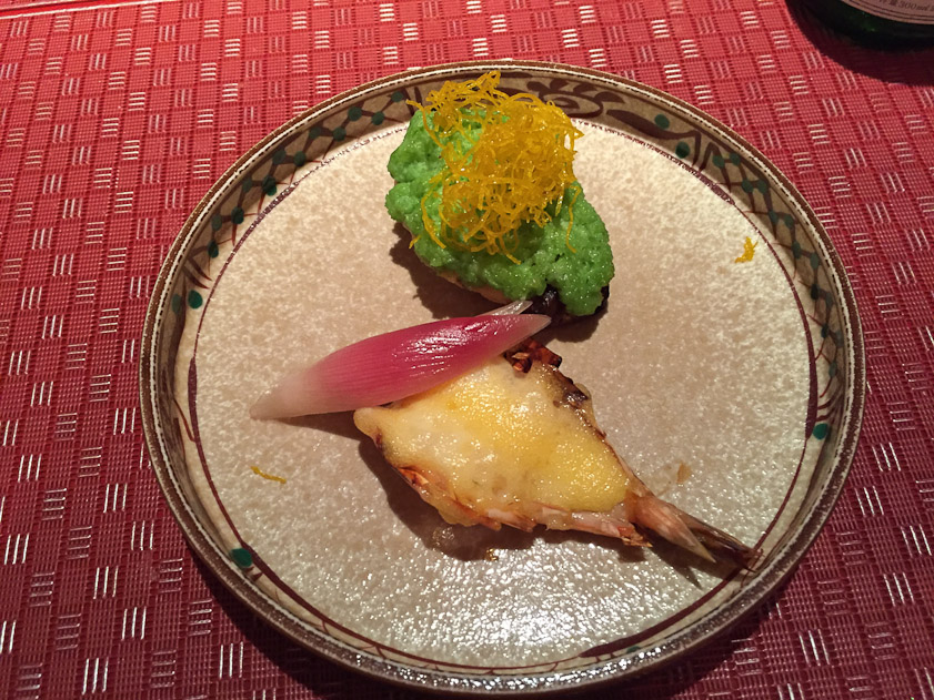 A stuffed shrimp and something vegetable.