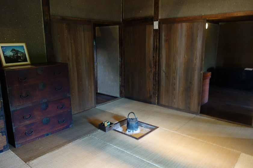 Umeda house interior. The small fire to heat the tea kettle is safely contained in a metal box filled with sand.