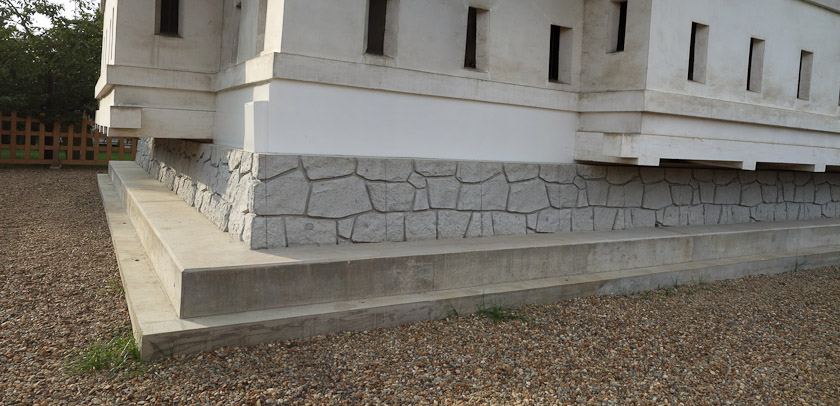 It seems that the castle is built on a wood frame, under which a steel frame was placed to support it while it was jacked up, put on rails, and pulled by teams of 100 volunteers to this location.