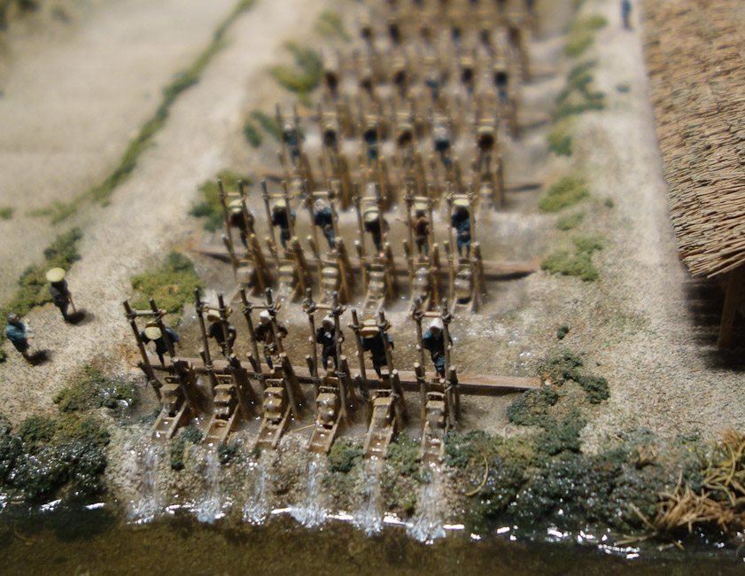 The water pumps are six water wheels abreast , each driven by one man.