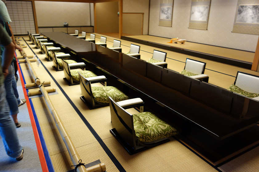 The table is a huge piece of lacquerware. There is a well below the table for diners' legs. This is more comfortable than sitting on your folded legs, but still not as comfortable for getting up and down as a Western table.