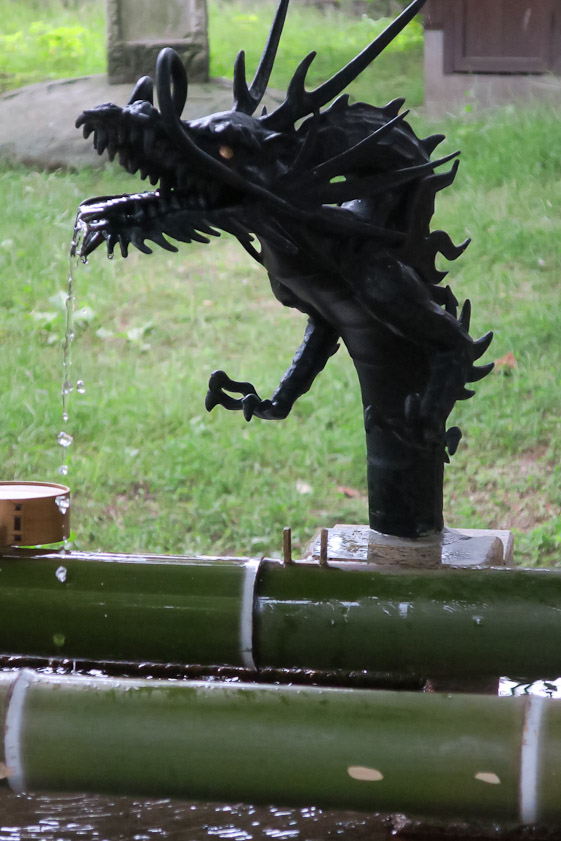 Ornamental dragon at the water basin where visitors purify themselves before entering a temple.