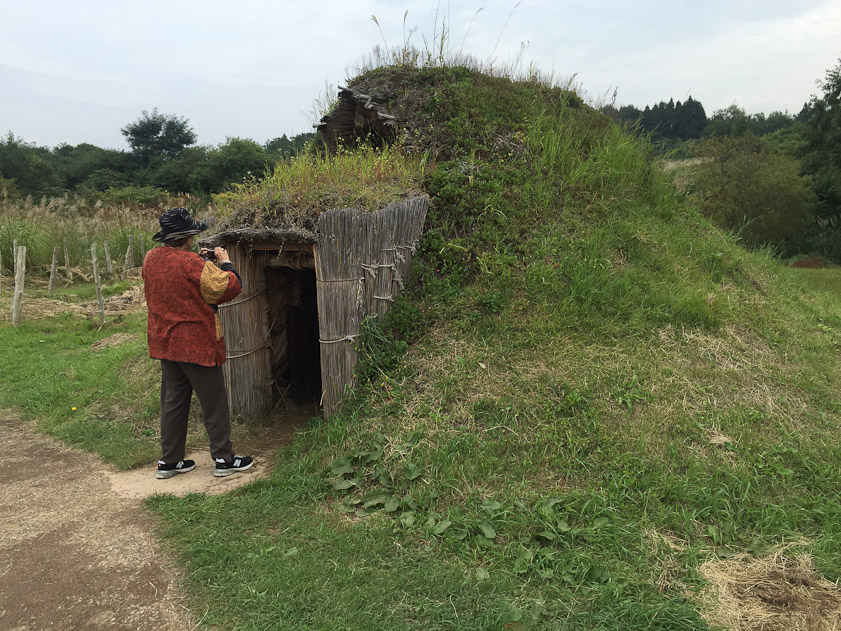 A reconstructed small pit house. Note the vent hole above and behind the entrance, to let out smoke.