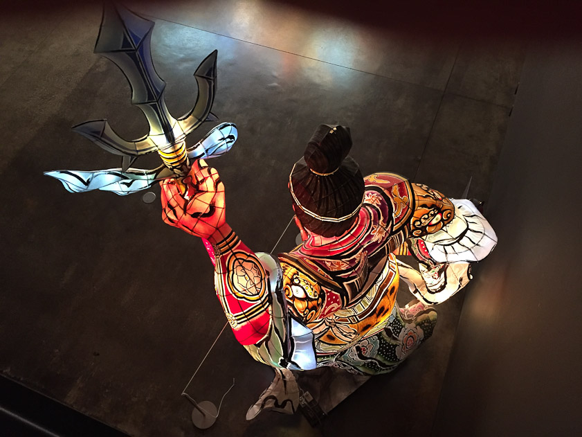 Nebuta features large mythological figures of painted paper wrapped over wire frames and lit from within.. I saw this warrior from above on a balcony.