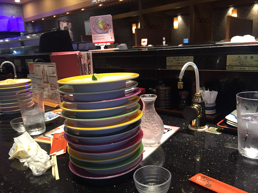 We visited Robert Yellin, the Japanese ceramics expert and gallery owner, in Kyoto and he took us out to lunch at a conveyor belt sushi restaurant. Each plate held two nigiri. Mariana and I ate off the near stack: 12 nigiri sushi each. The faucet dispenses boiling hot water to make your own tea.