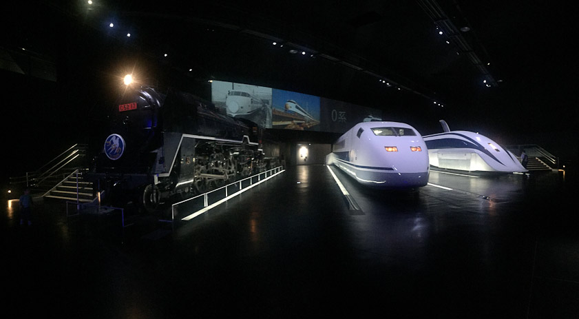 The entrance to the SCMAGLEV and Railway Park. The engine at left is C62 17, which ran at 129 km/hr in 1954. In the middle is the 300X Class 955 experimental Shinkansen, 443 km/hr in 1996. On the right is the MLX01-1 Superconducting Maglev engine, 581 km/hr in 2003.