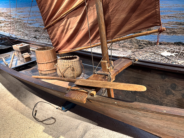 Note the cloth sails are still junk-rigged with horizontal battens/