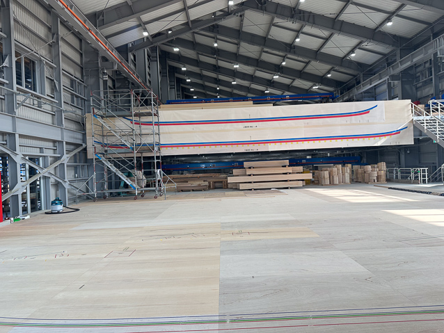 Timber is shaped in the large tempoary buildin Those are two full scale drawings pinned up.