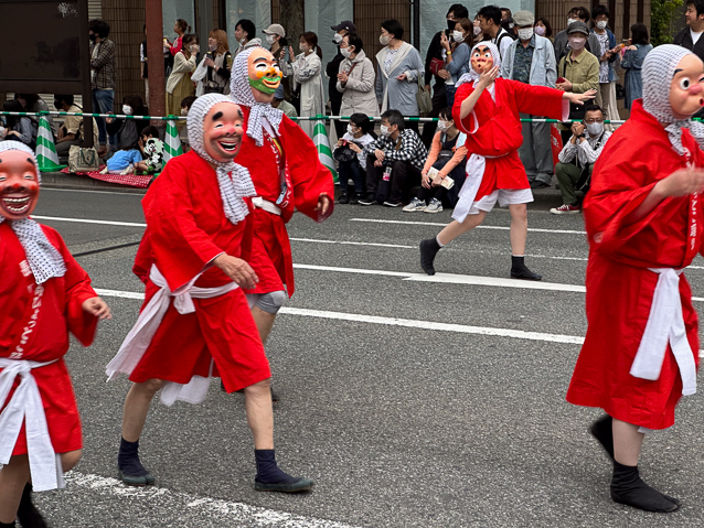 This men's group is dressed as Hyottoko, a legendary character. See his Wikipedia page.