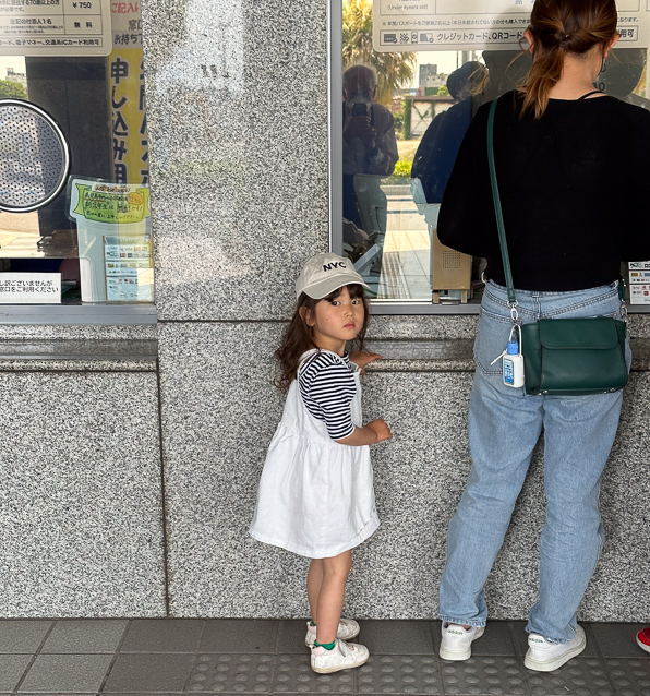 Another customer at the aquarium ticket window.