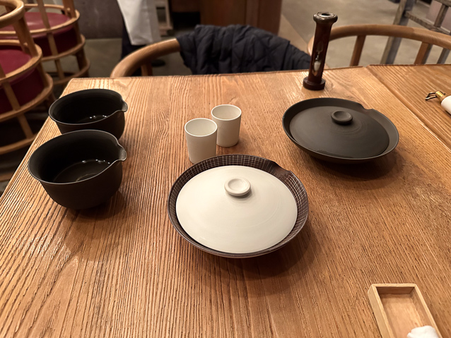The apparatus for brewing gyokuro: lukewarm water on the left, the shallow dishes holding the tea leaves at right, and two small cups to hold the brewed tea.