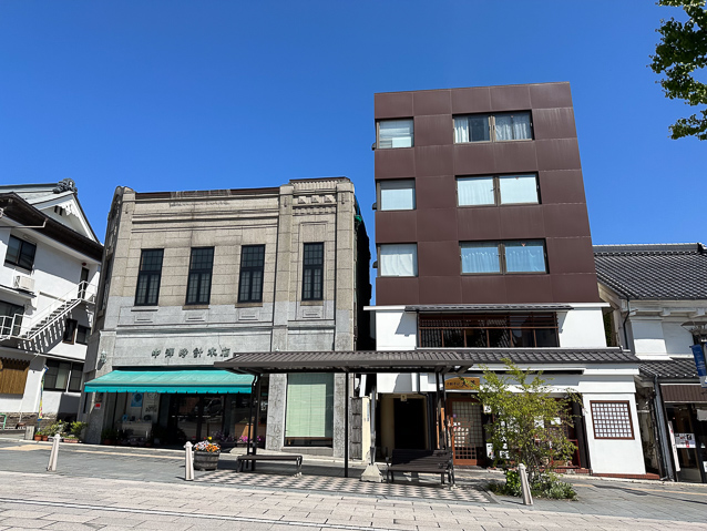 Good architecture of different styles across the streeet from the soba restaurant.