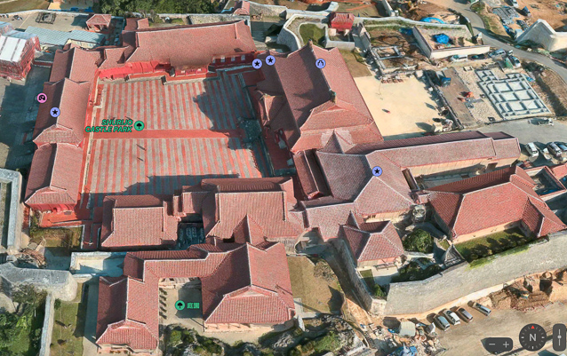 As of August 2023 both Apple Maps and Google Maps show Shurijo before the fire. Also note that the area at upper right shows the foundations of a building that had been completed by our bisit in  2023. The stripes of the pavement run North-South and the Seiden, the main palace building faces west.