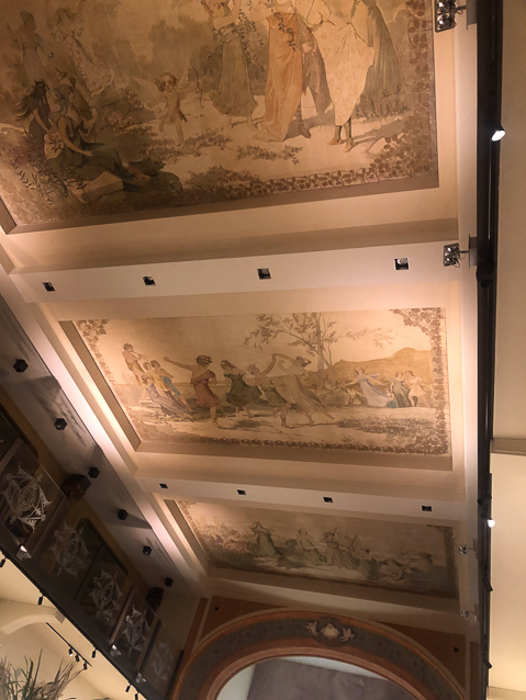 The ceiling of the dining room preserves the 19c paintings.