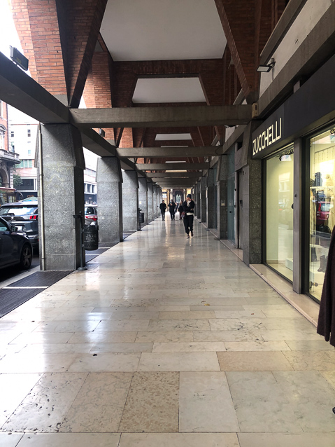 Bologna is famous for its arcades. This a modern one, not pock-marked or painted with graffitti.