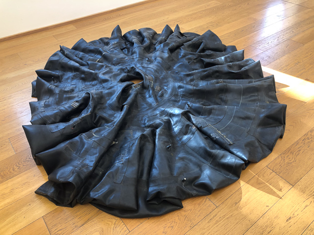 I'm sorry that I didn't photograph the label for this. I thoight it was an inner tube, but now I can see all the patches and several nipples. So it was constructed of many pieces of black rubber.