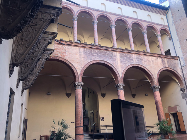 The interior courtyard features large ornate brackets on the wall at the top left.
