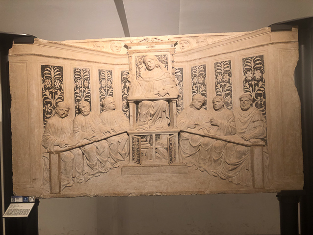 The museum has several funerary monuments to schollars showing the deceased lecturing and students on either side listening or taking notes.
