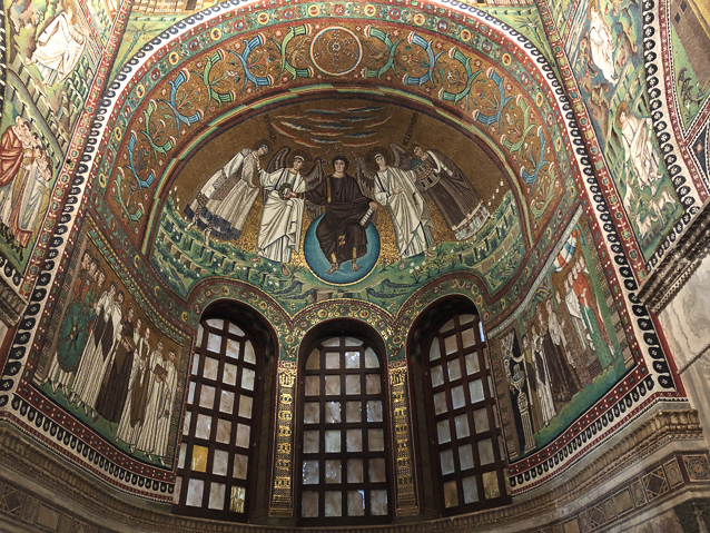 The apse at the east end of the presbytery. The mosaic of Emperor Justinian and his court is to the lrft og the windows, and Theodora and her court are on the right. The semidome mosaic shows Jesus and the authors of the four gospels, Matthew, Mark, Luke and Josn.