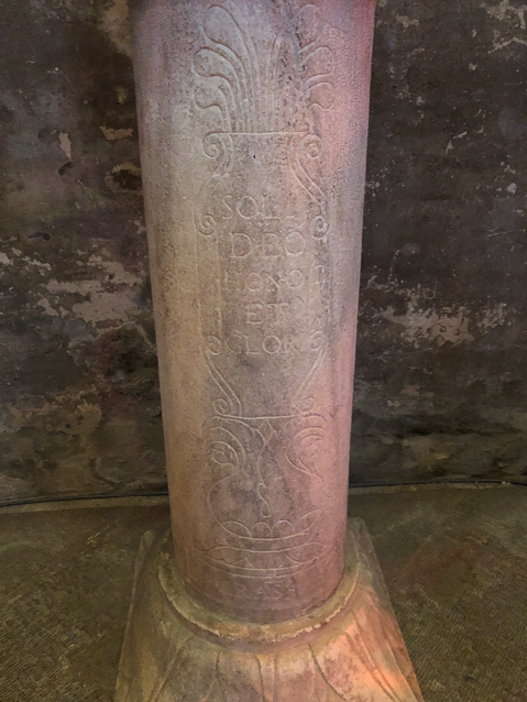 Its supporting column has a shallow carving.