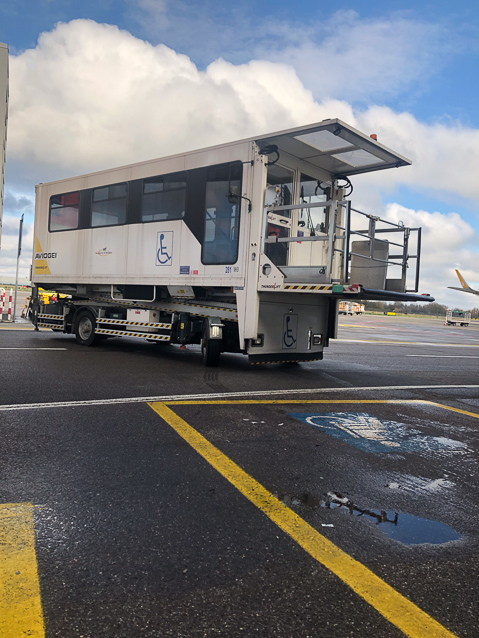 I rolled onto that little porch at the front of the van, then moved into the compartment behind it, and the van took off for the parked airplanI