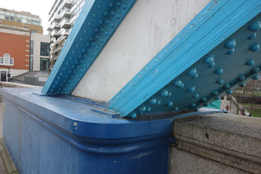 A closeup at the south abutment, showing six layers of iron riveted into a suspension loop.