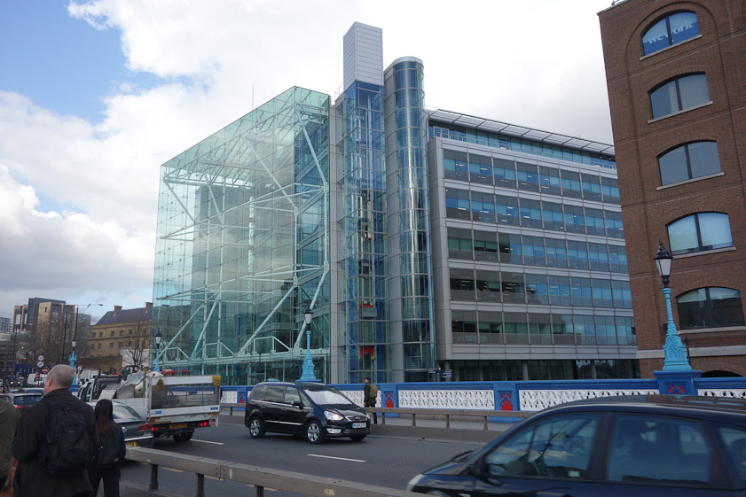 Modern glass building facing the Tower.
