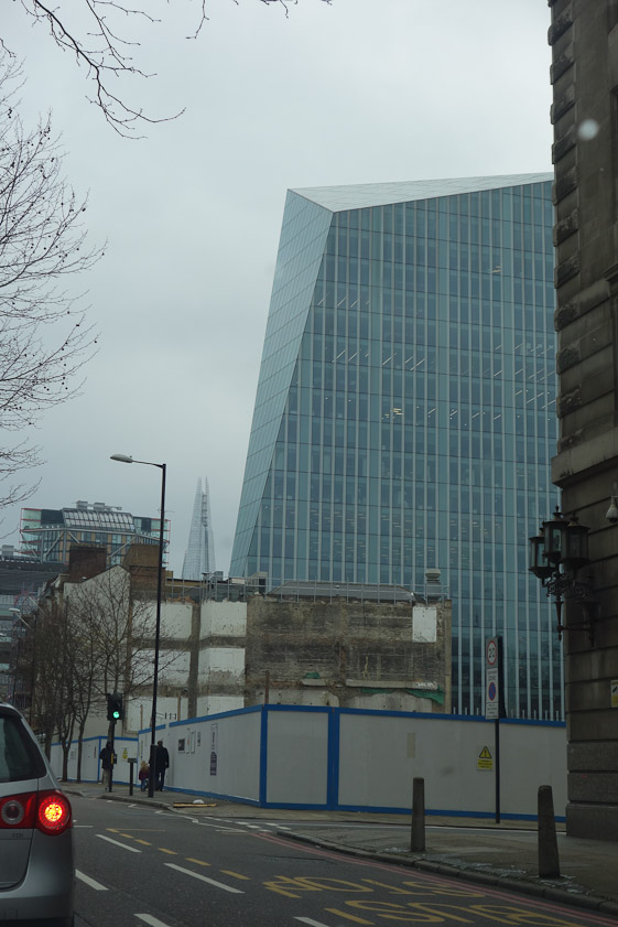 An angular glass building, with The Shard in the background.
