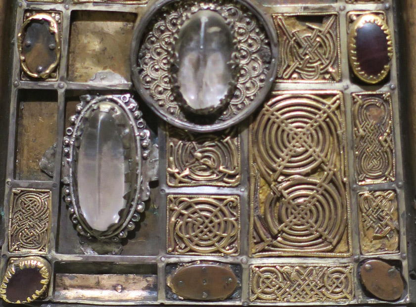 At the bottom of the shrine are spirals similar to earlier Celtic objects. Note the very fine beading around the panel at center bottom.